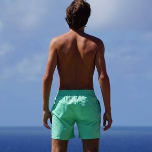 Back view of Mens swim shorts in solid green by designer Lotty B Mustique for Pink House resortwear