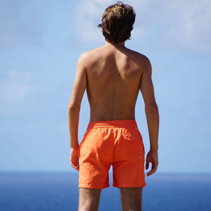Comfortable orange swim shorts by designer Lotty B Mustique for Pink House vacation essentials