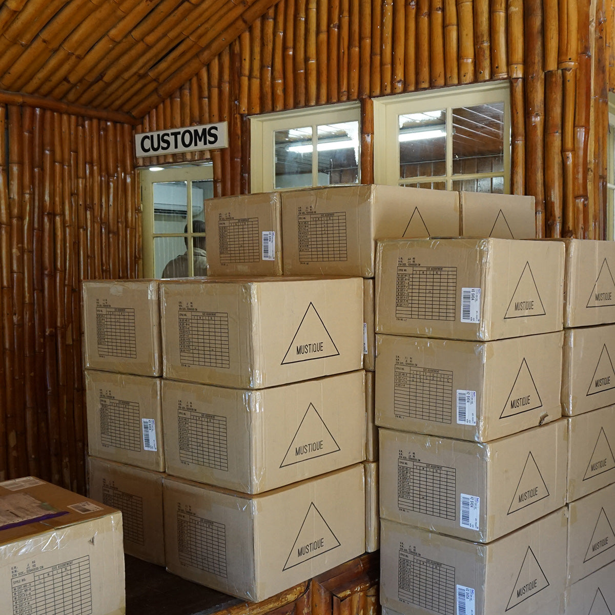 Boxes of Pink House Mustique clothing and resortwear awaiting processing at Mustique Airport customs