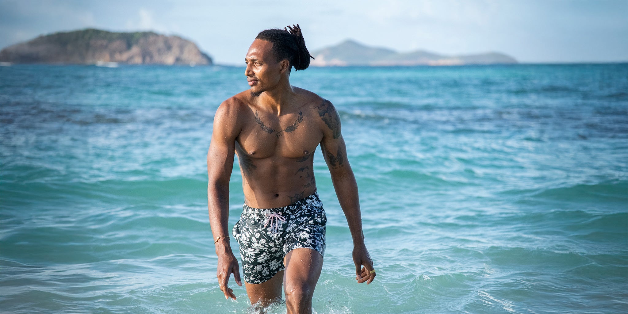 Pink House Mustique Resort 2026 men’s swimwear made in Portugal, luxury linen and printed swim shorts on Lagoon Beach Mustique.