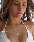 Close up of 18 carat gold Mustique island pendant necklace luxury island jewellery made in England