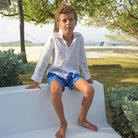 Optic white pure linen children's shirt worn with blue Frigate bird swim shorts