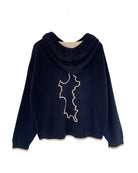 Pink House x Malin Darlin navy cashmere hoodie with Mustique island outline on back – luxury knitwear inspired by island life.