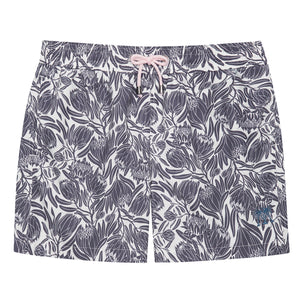 Mens swim shorts in navy blue floral Protea print by designer Lotty B for Pink House Mustique