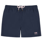 Close-up of navy blue swim trunks shorts with a pocket and button on a white background