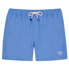 Close-up of blue swim trunks shorts with a pocket and button on a white background