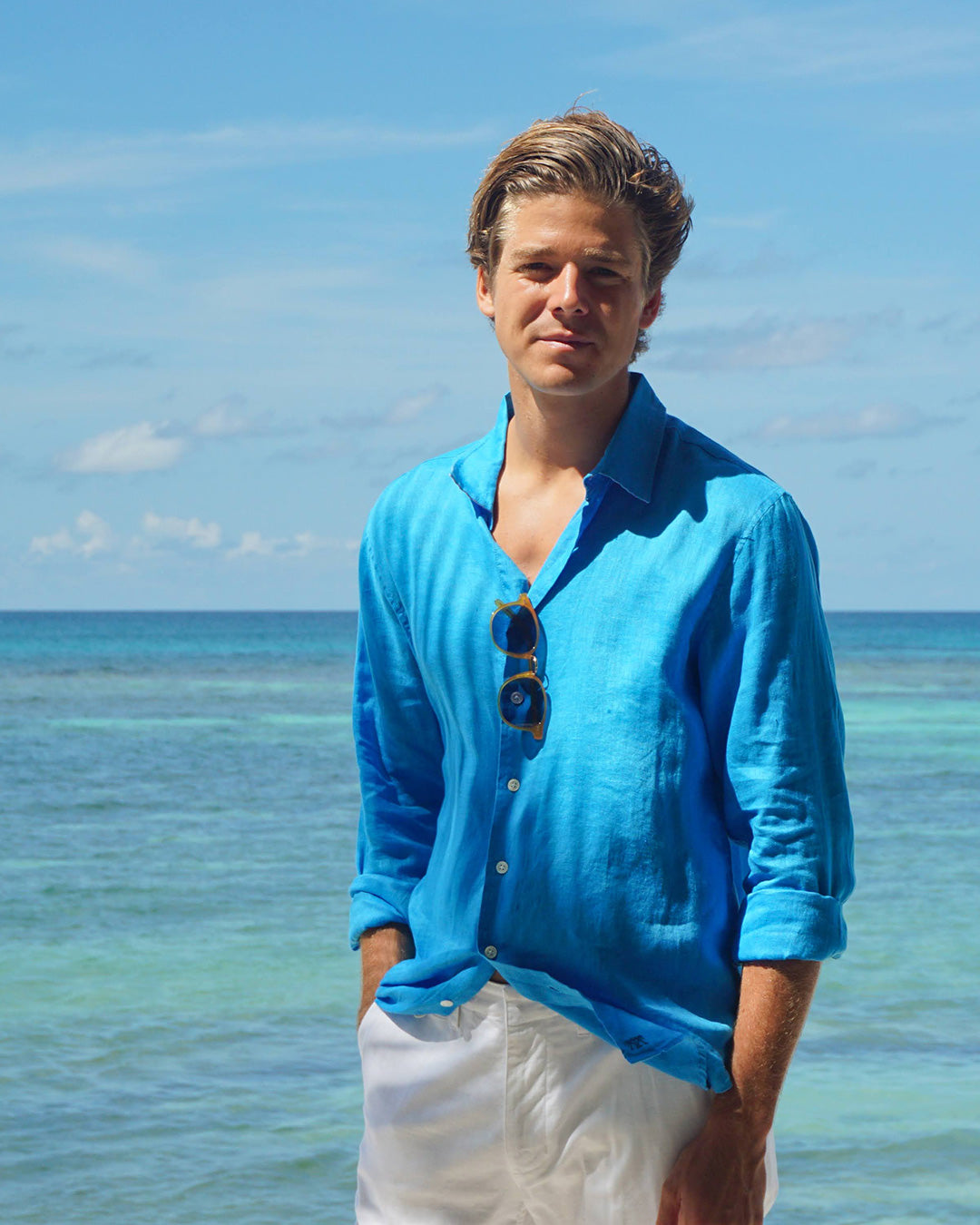 Island lifestyle on Lagoon bay in mens bright turquoise linen shirt, Mustique 