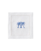 White linen cocktail napkin with blue embroidered crossed palms – elegant tropical napkin