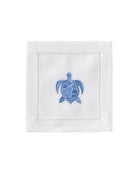 White linen cocktail napkin with blue embroidered turtle – ocean-inspired island table linen