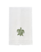 White linen hand towel with green turtle embroidery – nature-inspired coastal bathroom or luxury guest towel