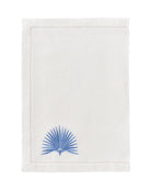White linen placemat with azure blue fan palm leaf embroidery – luxury coastal table linen by Pink House Mustique