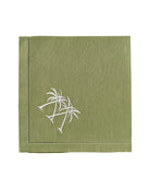 Sage green linen napkin with white crossed palms – elegant tropical table linen from Pink House Mustique