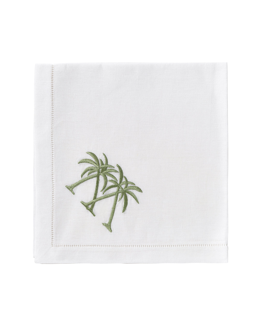 White linen napkin with green crossed palm embroidery – tropical table accessory by Pink House Mustique