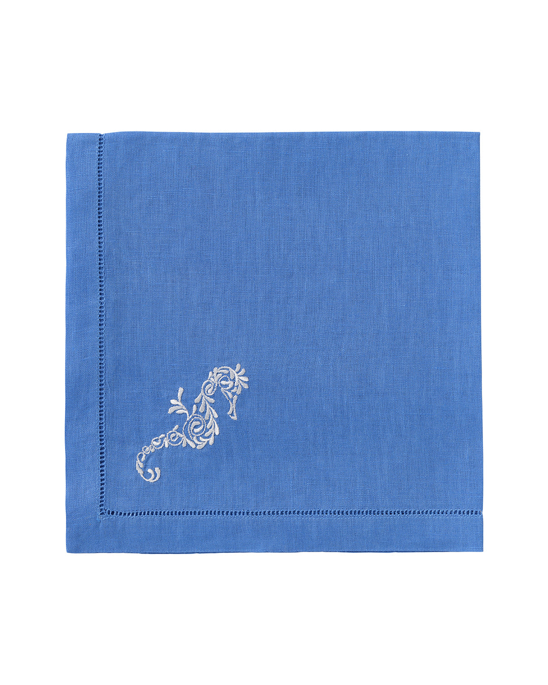 Pure linen napkin in blue with white embroidered seahorse motif – coastal luxury table linen for beach house or summer dining
