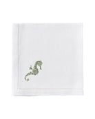 White linen napkin with green embroidered seahorse – artisan table linen for summer entertaining and coastal living