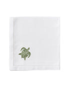 White pure linen napkin with sage green embroidered turtle – artisanal coastal table linen, luxury finish