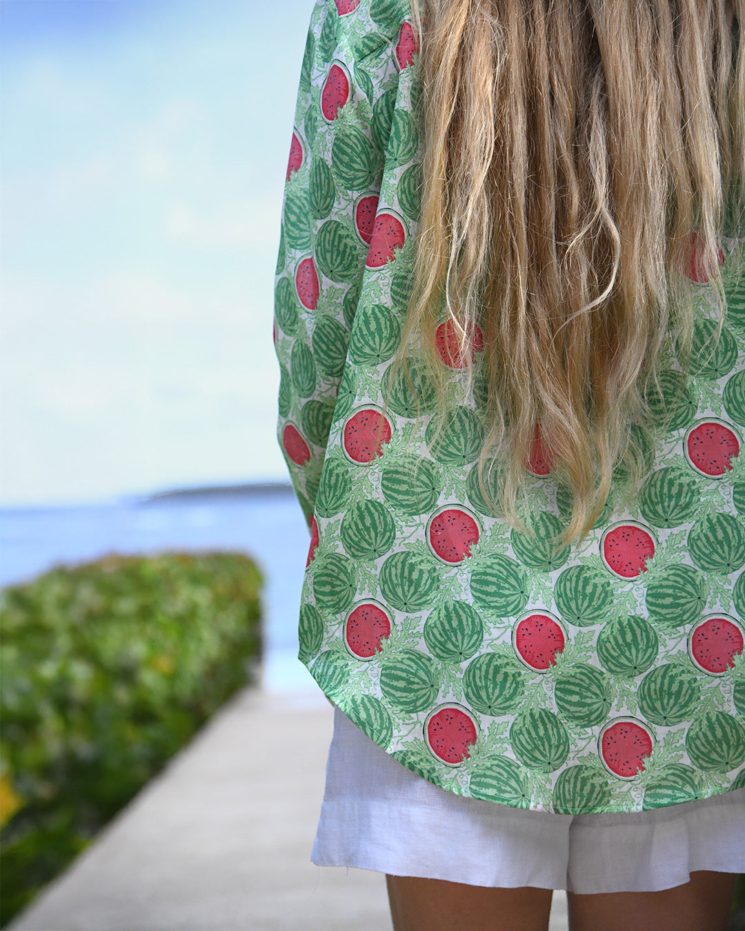 Close-up of Watermelon Green Anastasia linen shirt showing curved hem, relaxed fit and watermelon print