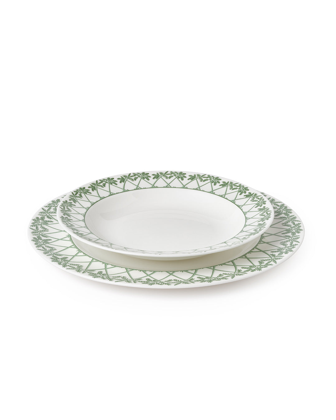 Showing the relative size of the dinner plate under the rimmed bowl in Palms Sage Green design by Pink House Mustique.