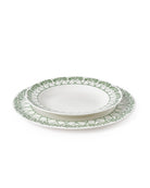 Showing the relative size of the dinner plate under the rimmed bowl in Palms Sage Green design by Pink House Mustique.