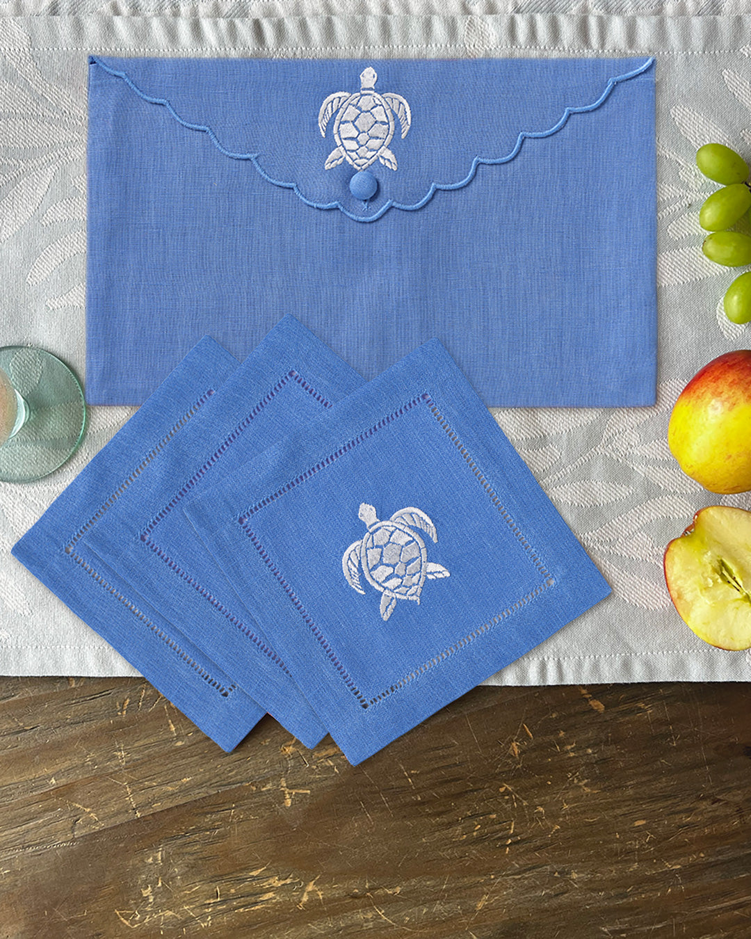 Azure blue linen cocktail napkins with turtle embroidery and matching envelope case, by Pink House Mustique.