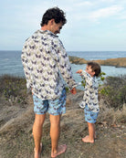 Father and son in matching Monkey & Palms linen shirts and swim shorts, coastal family mini-me style by Pink House Mustique