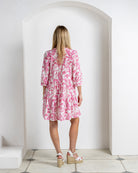 Back view of silk crepe Amy dress in Parrot pink – tiered skirt and soft gathers in tropical bird print luxury island style