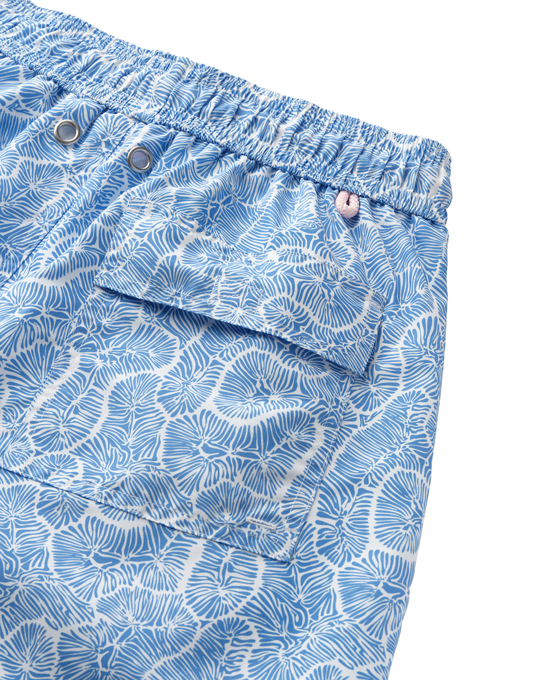 Detail of back pocket on blue CORAL STONE swim shorts – sustainable recycled swimwear by Pink House Mustique.