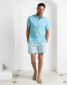 Men’s turquoise cotton polo with Coral Stone Aqua swim shorts by Pink House Mustique, resort wear 2026.