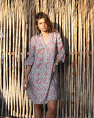 Lottie wearing Parrot Coral/Turquoise Decima Dress by Pink House Linen – breezy linen dress with V-neck and ¾ ruffle sleeves, designed for warm-weather elegance.