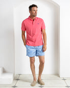 Designer men’s pink cotton polo with Coral Stone Blue swim shorts, island resort wear by Pink House Mustique.