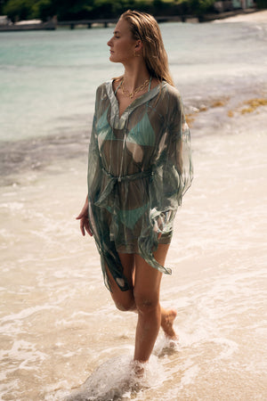 Luxury vacation style, chiffon silk Cosima Kaftan in lichen green Egret design, Cotton House beach, Mustique