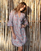 Tropical-inspired Pink House Linen Decima Dress in Parrot Coral/Turquoise – soft linen fabric with exotic bird print, ideal for travel, beach days, and island life.