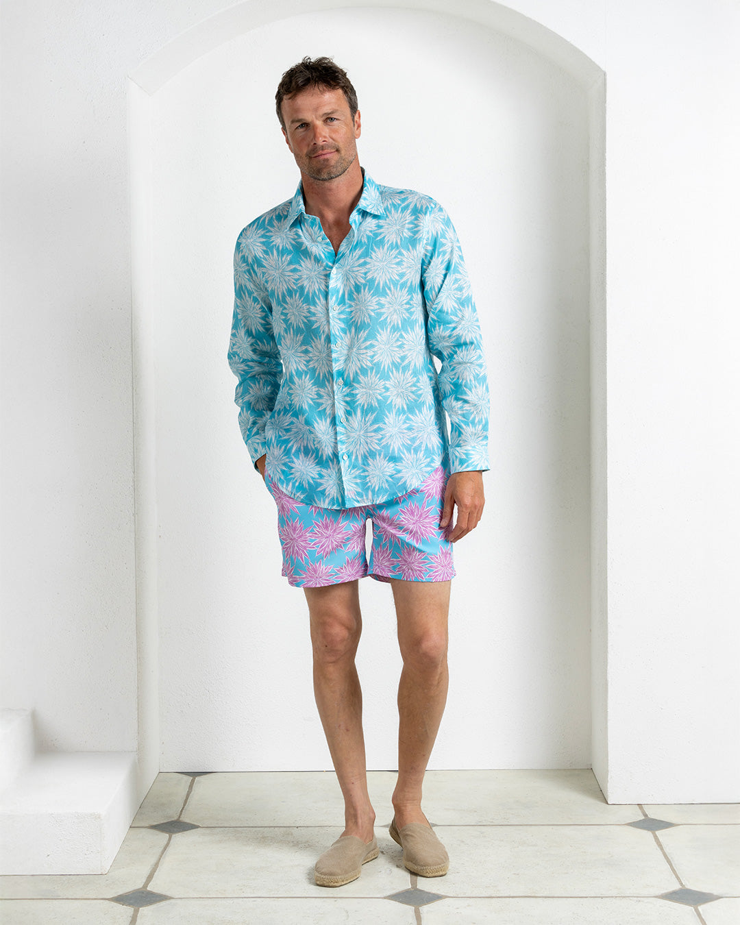 Men’s linen shirt in Agave turquoise paired with Agave turquoise and pink swim shorts, Pink House Mustique Resort 2026.