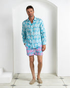Men’s linen shirt in Agave turquoise paired with Agave turquoise and pink swim shorts, Pink House Mustique Resort 2026.