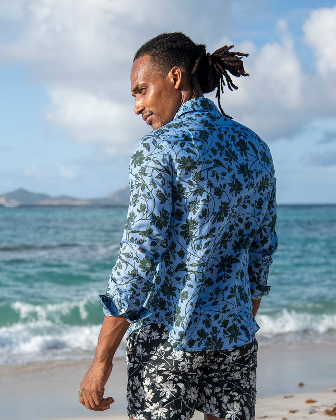 Back view of men’s Iguana linen shirt in blue spruce by Pink House Mustique, effortless island resort look.