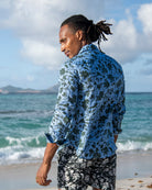 Back view of men’s Iguana linen shirt in blue spruce by Pink House Mustique, effortless island resort look.