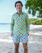 Man wearing Watermelon Green linen shirt with matching swim shorts on a Caribbean beach