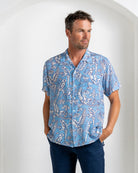 Luxury men's silk shirt in parrot blue print, short sleeves, vacation-ready style from Pink House Mustique