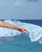 Close-up detail of Lotty B Blue Pineapple silk crepe de chine sarong flowing in the Caribbean breeze on Mustique.