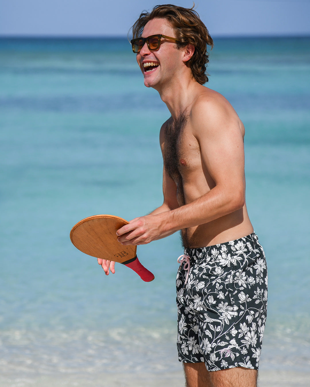 Designer Iguana Spruce swim shorts with recycled shell fabric, elastic waistband and secure Velcro® back pocket.