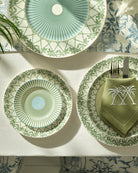 Elegant fine bone china charger and side plates stacked on salad plate in Palms Sage Green design by Pink House Mustique.