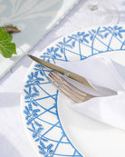 Close-up of Palms Azure Blue fine bone china dinner plate with intricate palm frond rim design.