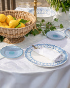 Elegant Palms Azure Blue fine bone china dinner set styled with lemons and linen napkins for luxury dining.