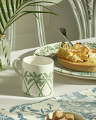 Fine bone china mug and dessert plate in Palms Sage Green by Lotty B Mustique, elegant English tea setting.