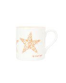 Side view of fine bone china Seastar mug in orange with floral starfish design from Lotty B Mustique.