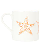 Fine bone china orange Seastar mug by Lotty B Mustique featuring hand-painted starfish pattern and orange rim.