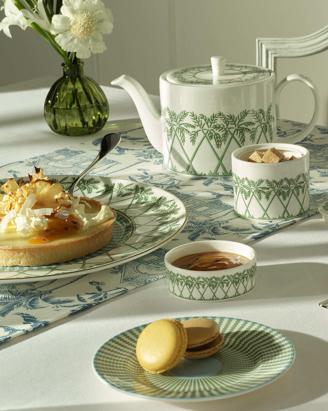 Fine bone china teapot, sugar pot and plates in Palms Sage Green by Lotty B Mustique, elegant English table setting.