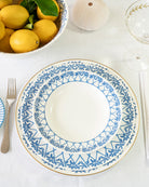 Luxury fine bone china Palms Azure Blue rimmed bowl and Azure Blue set arranged for a tropical dining table.