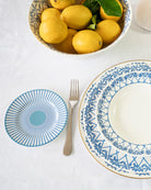 Fine bone china Palms Azure Blue side plate styled with matching charger and bowl — elegant coastal table setting with lemons.