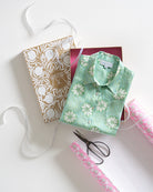 Luxury gift wrapping service with Lotty B Sand Dollar green silk shirt and Pink House Mustique signature packaging.